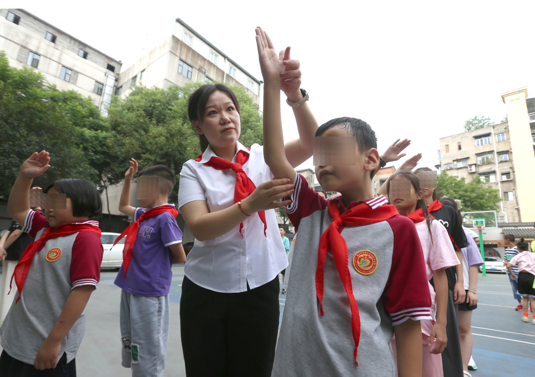 曾真老师正在纠正学生的行礼动作。.JPG